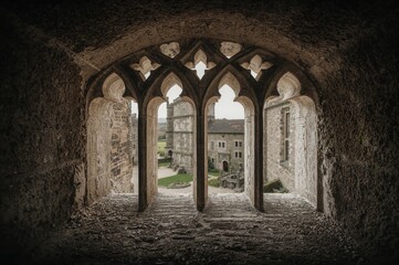Naklejka premium Looking outside from a window with stone dividers