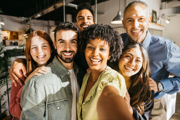 Group of diverse business people taking selfie in office