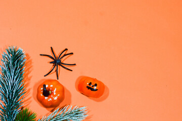 Halloween double border of scattered candy and decor. Flat lay over an orange background with copy space.