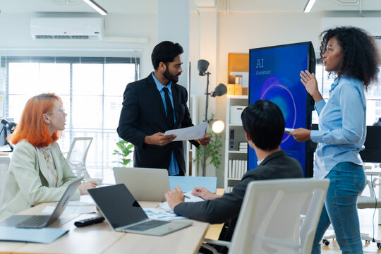 Diverse creative team use Ai Assistant (artificial intelligence assistant) on AI-assisted display for Marketing Data Analyst meeting at office.Coding team,develop Ai Assistant,business brainstorming 