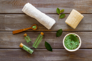 Spa pedicure accessories and organic cosmetics products - tea tree essential oil and sea salt near...