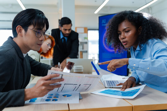Diverse creative team use Ai Assistant (artificial intelligence assistant) on AI-assisted display for Marketing Data Analyst meeting at office.Coding team,develop Ai Assistant,business brainstorming 