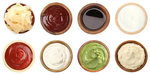 Different condiments isolated in bowls on white, set. Top view