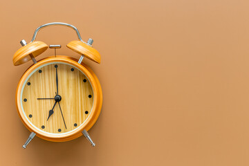 Vintage wooden alarm clock with bells at seven o'clock. Morning routine. In time concept