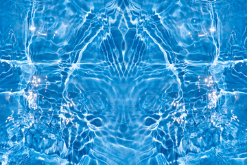 Blue water with ripples on the surface. Defocus blurred transparent blue colored clear calm water surface texture with splashes and bubbles. Water waves with shining pattern texture background.
