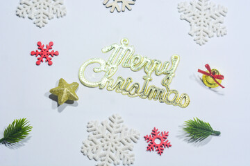 Top view of beautifully wrapped Christmas gifts with red and green ornaments, fir branches, and festive decorations on a light background