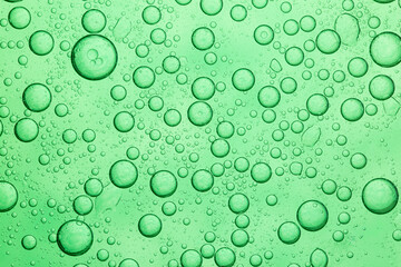 Green macro bubble texture,Macro microscope green bubble texture, Close-up Green bubbles and drops oil background . blue green water bubbles, close up golden oil drop for cosmetic