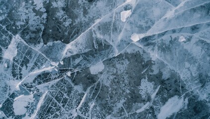Naklejka premium Photography of early spring in rural landscape. River covered with blue and gray ice. Warming weather causes ice to crack and break. Nature's beauty concept. Aerial perspective