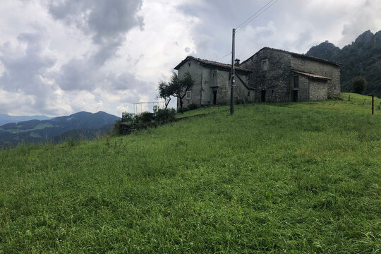 Historical Stone Farmhouse of Zambla Alta Mountain Village, in the Italian Alps, During a Cloudy Day. Beautiful View of Mount Alben Peak, Bergamo Province, Italy