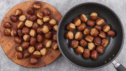 Fototapeta premium Getting chestnuts ready to fry: overhead shot of chestnuts with a skillet