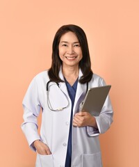 Portrait of asian female doctor in medical uniform with stethoscope on peach color background.
