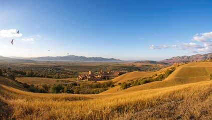 Fototapeta premium Wide-angle perspective of rural landscapes featuring sunlit peaks and a tiny settlement nestled in the Rif highlands of the north