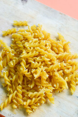 Uncooked elbow macaroni on white background