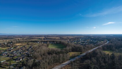 Aerial perspective of a countryside landscape featuring homes and trees, showcasing suburban development and natural scenery