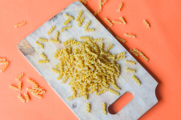 Uncooked elbow macaroni on white background