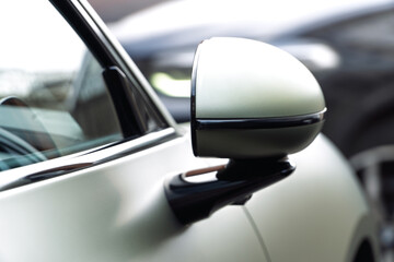 Car side mirror with integrated camera closeup, cam for driver safety and visibility. Car side view...