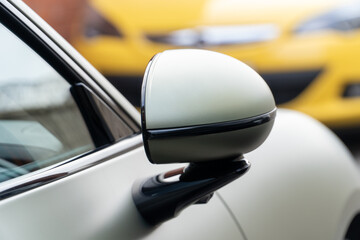 Car side mirror with integrated camera closeup, cam for driver safety and visibility. Car side view...