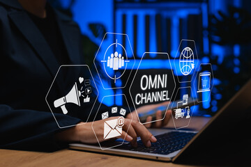 Omnichannel marketing concept. Person using laptop with icons of omni channel, email, e-commerce, social media, logistics, representing seamless customer experience across multiple digital platforms.