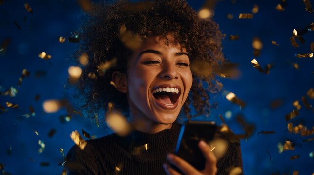 Cheerful young woman looking at smartphone with confetti falling against a blue background, concept for digital celebration, social media engagement and mobile communication