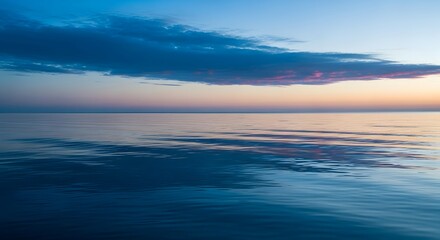 Fototapeta premium Tranquil ocean scene with soft waves and vibrant sunset colors reflecting on the water surface, symbolizing relaxation, calmness, and natural beauty.