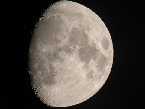 Detailed waxing gibbous moon with visible craters and maria. Crisp lunar close-up against deep black sky.