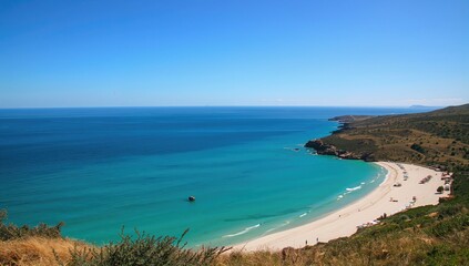 A clear blue sky above a coastal town