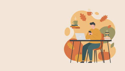 Cozy autumn workspace Man using phone and laptop among fall decor