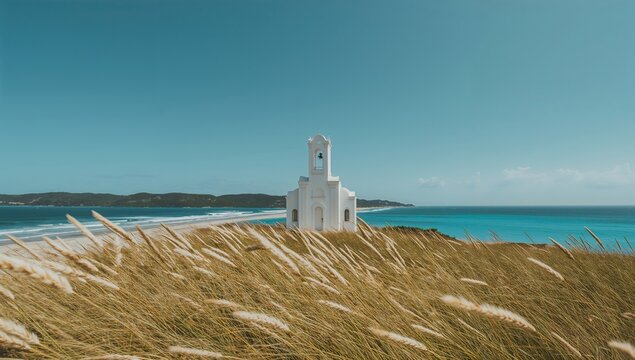 Seaside white chapel surrounded by high grass on an island with water and sky in the background, summer vacation, natural scenery, architecture, white structure - Powered by Adobe