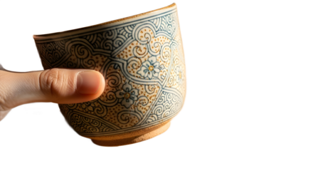 Decorated teacup held in sunlights glow