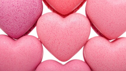 Obraz premium Detailed close-up of delicate small heart-shaped pink and purple macarons for a romantic celebration on February 14th, isolated on a white background