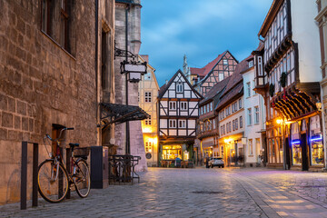 Charming Quedlinburg town evening street view illuminated with lights old St. Nicholas Church St....