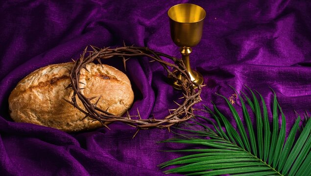 Crown of thorns placed with bread, chalice, and palm leaf on a purple fabric backdrop, symbolic representation of sacrifice