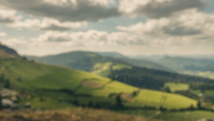 Fototapeta premium Blurred mountain landscape featuring fields and pathways, seasonal change