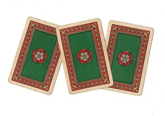 Fototapeta premium A hand of vintage playing card backs isolated on a white background.
