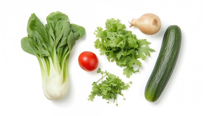 Fresh vegetables including pepper, pak choi, onion, rucola, tomato, and cucumber arranged on a white backdrop. Concept focused on nutritious eating and food. Artistic presentation of salad