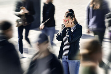 Stress, anxiety, panic attack or fear. Mental health disorder. Depressed woman in public. Crowd of people. Schizophrenia or phobia. Paranoia or Agoraphobia. Introvert person in busy city street.