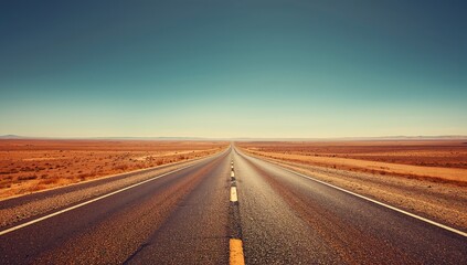 Fototapeta premium The vast highway stretches through endless plains. Image with color filter.