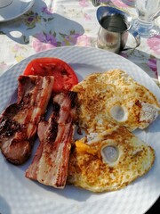 Classic Full Breakfast with Fried Eggs, Grilled Bacon and Tomato Slices