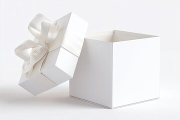 Open white square gift box with detached lid decorated with white ribbon and bow on white background. Studio photo with soft lighting. Celebration and holiday packaging concept.