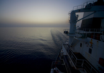 View of the stern of a merchant ship at sea in the morning