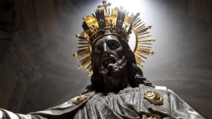 Solemn Ecclesiastic Sculpture of Christ the King with Skull Face and Gold Crown in Dark Interior