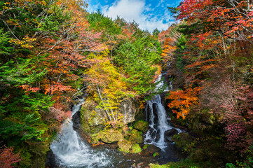 Ryuzu Waterfall or Ryuzu Cascades with autumn background is one of Landmark in Nikko to see autumn colors Nikko, Tochigi, Japan