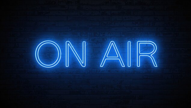 Glowing ON AIR sign illuminating a dark brick wall