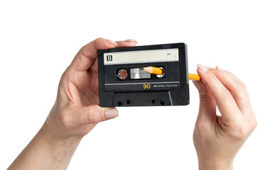 Woman’s hands rewinding audio cassette tape with a pencil, transparent background PNG. Vintage analog music nostalgia, classic 1980s retro sound, isolated object concept