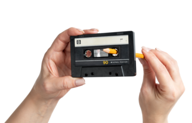 Woman’s hands rewinding audio cassette tape with a pencil, transparent background PNG. Vintage analog music nostalgia, classic 1980s retro sound, isolated object concept