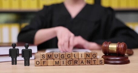 Judicial proceedings unfold as a judge addresses serious issues around migrant smuggling and justice