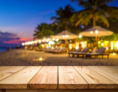 A wooden table foregrounds a blurred beach scene. Sunset hues paint the sky, lights glow along the shore, palm trees sway near loungers