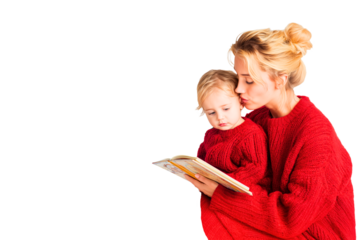 caucasian mother and 2-3 year old baby in cozy red winter clothes are reading a book together; kid is listening with curiosity