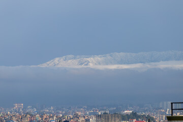 Snowfall in Kathmandu City with Hills Covered in Snow