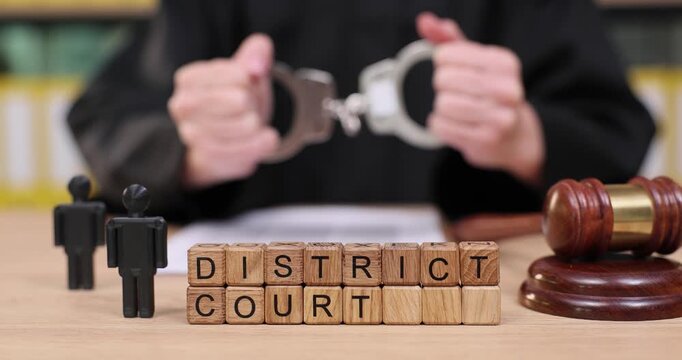 Exploring the dynamics of justice at a district court setting with handcuffs and a judge's gavel